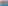 Dense urban skyline along a wide beach and calm sea, hazy morning light.