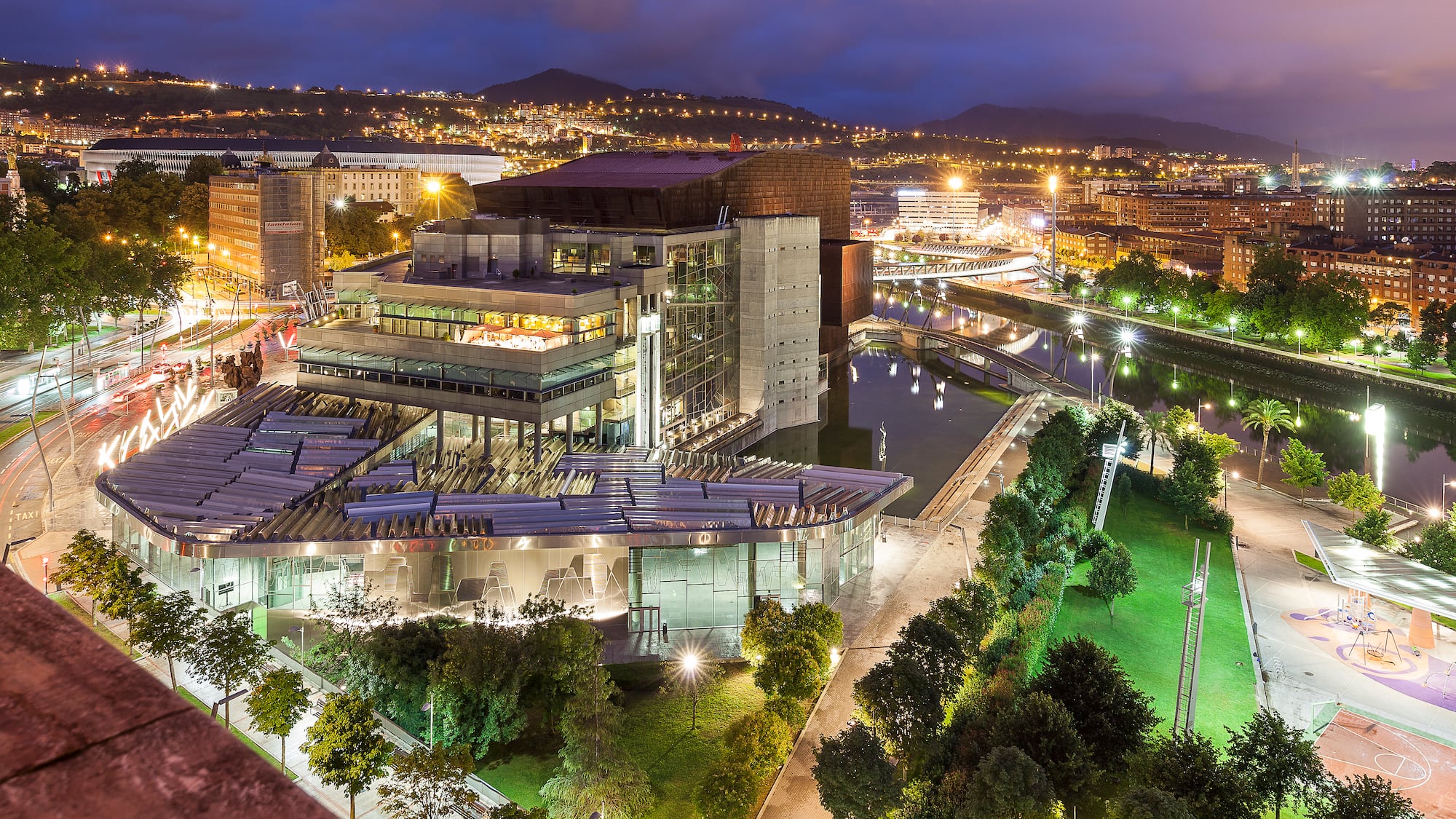 a city with a large building and trees