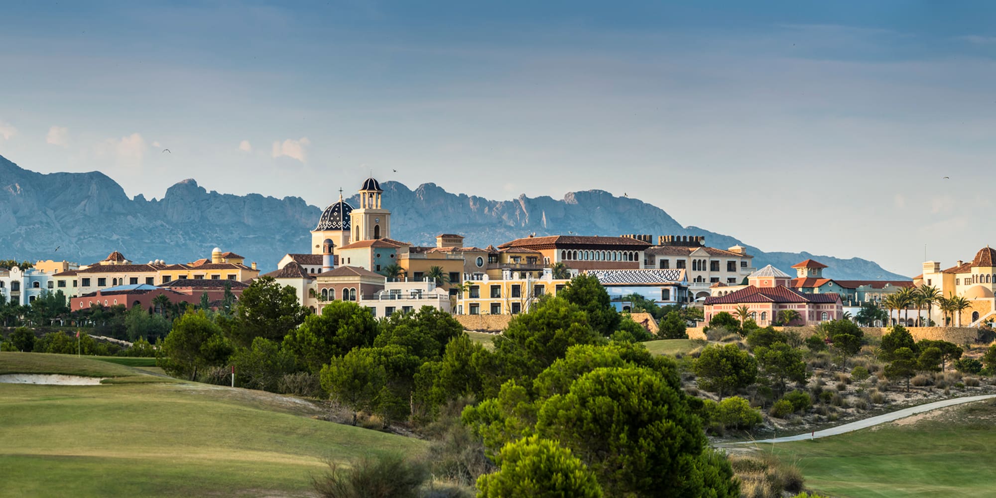 a group of buildings in a grassy area
