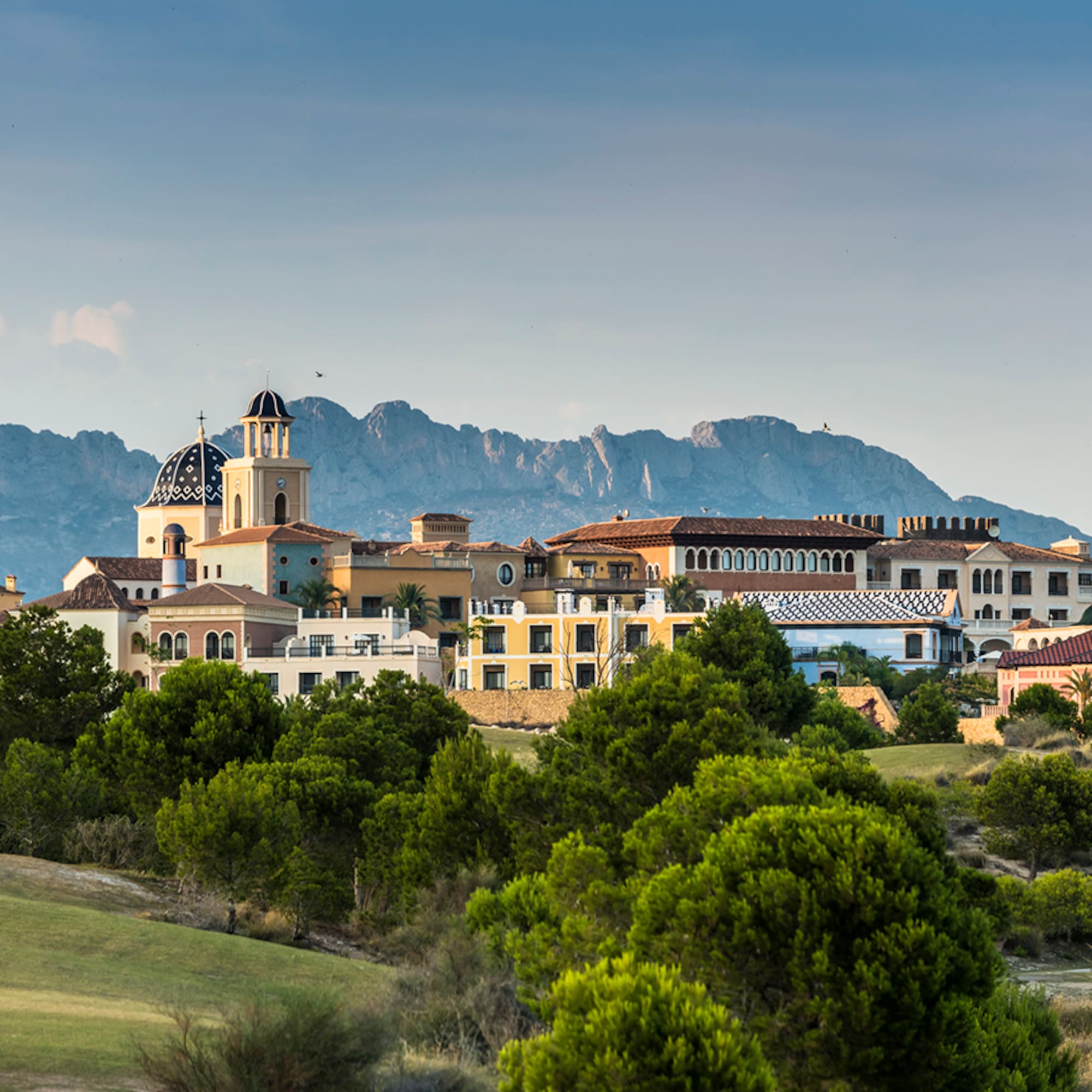 a group of buildings in a grassy area