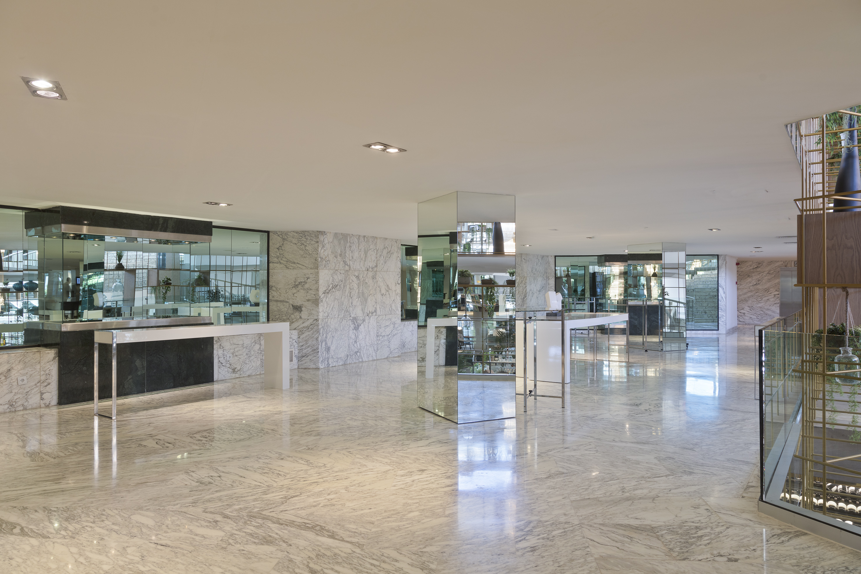 Luxury marble lobby interior with reflective surfaces and modern design.