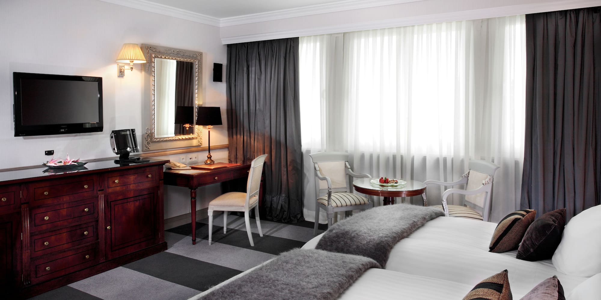 a room with two beds and a desk