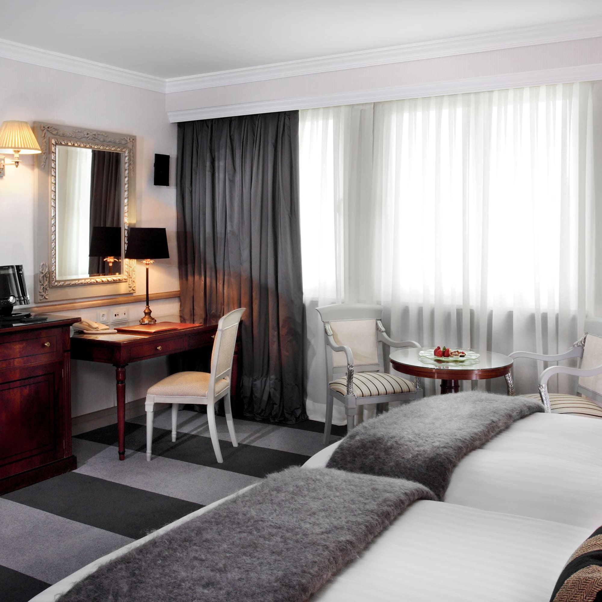 a room with two beds and a desk