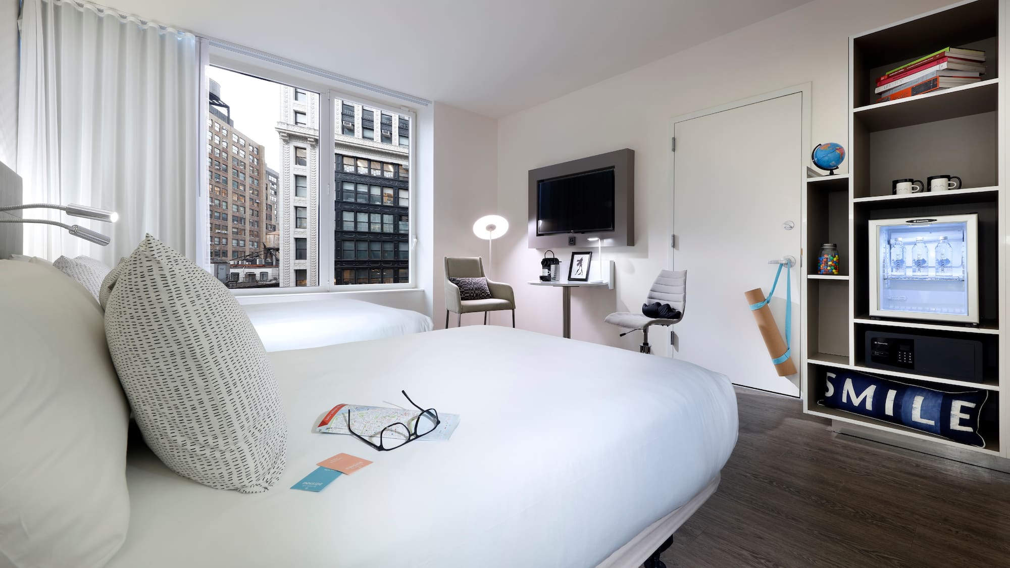 a room with two beds and a tv