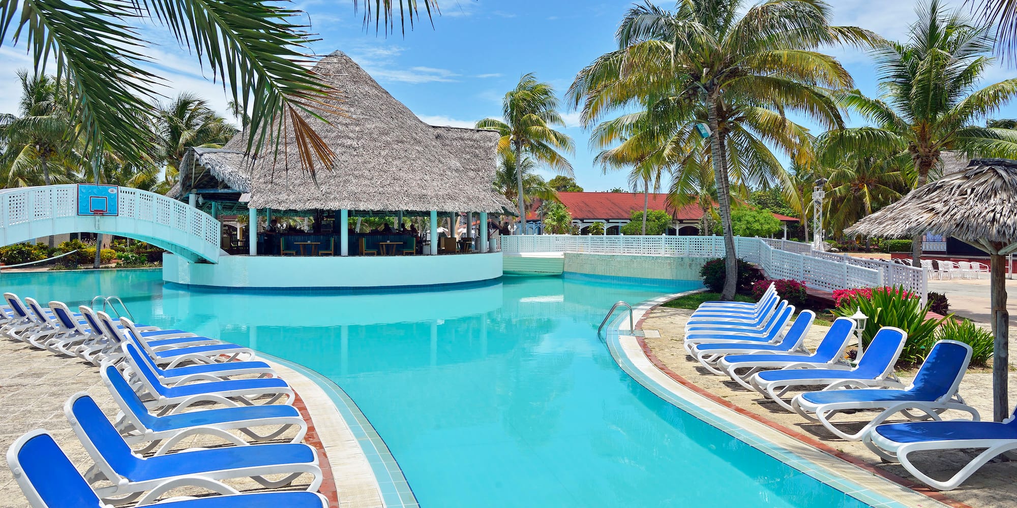 a pool with lounge chairs and a bar