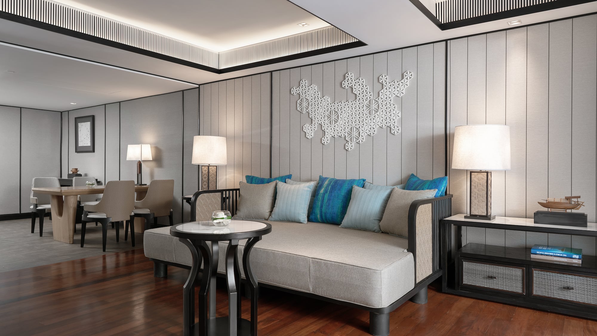 a room with a couch and table and lamps