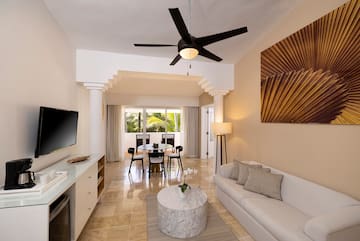 a living room with a table and a tv