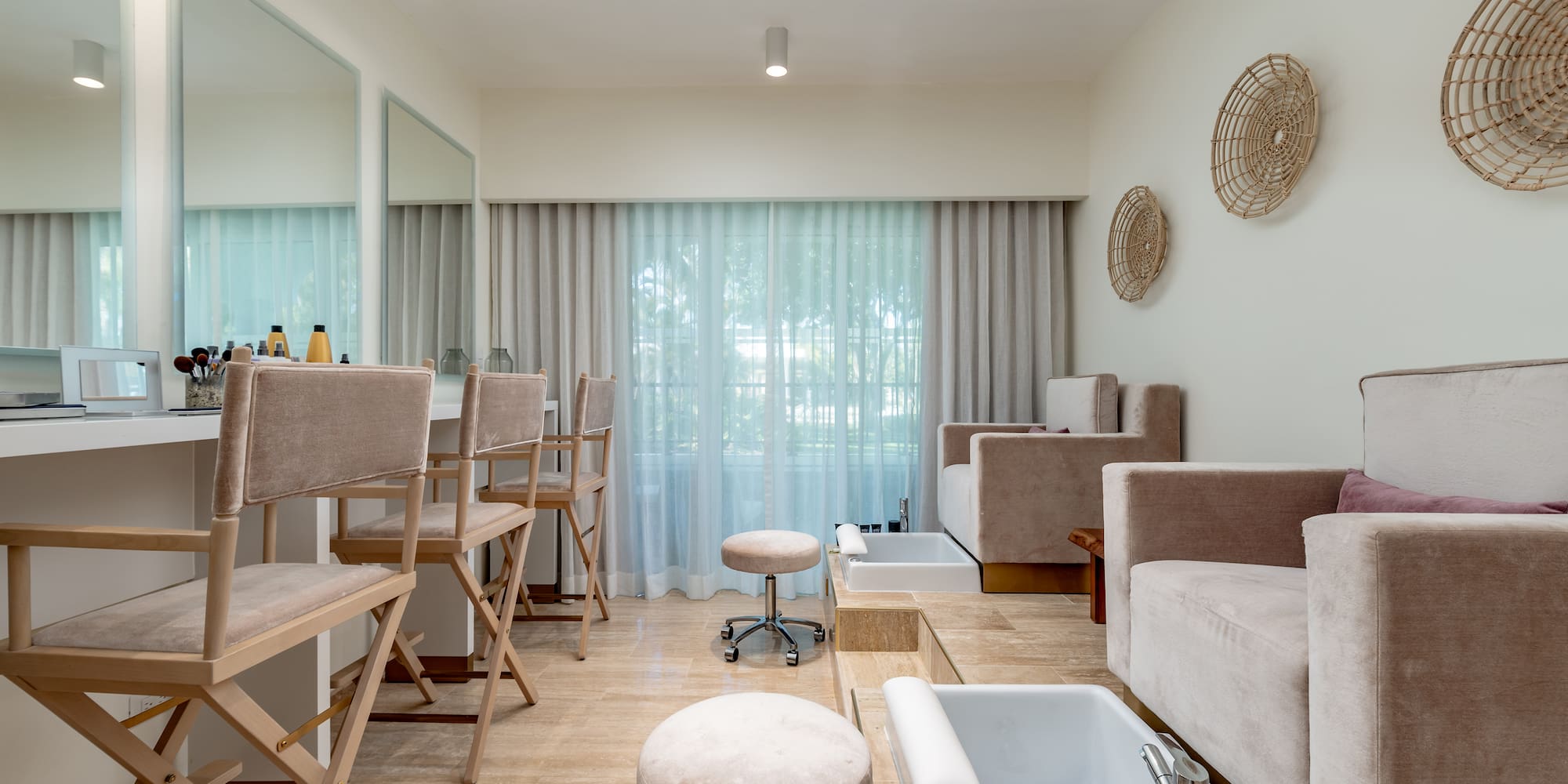a room with a sink and chairs