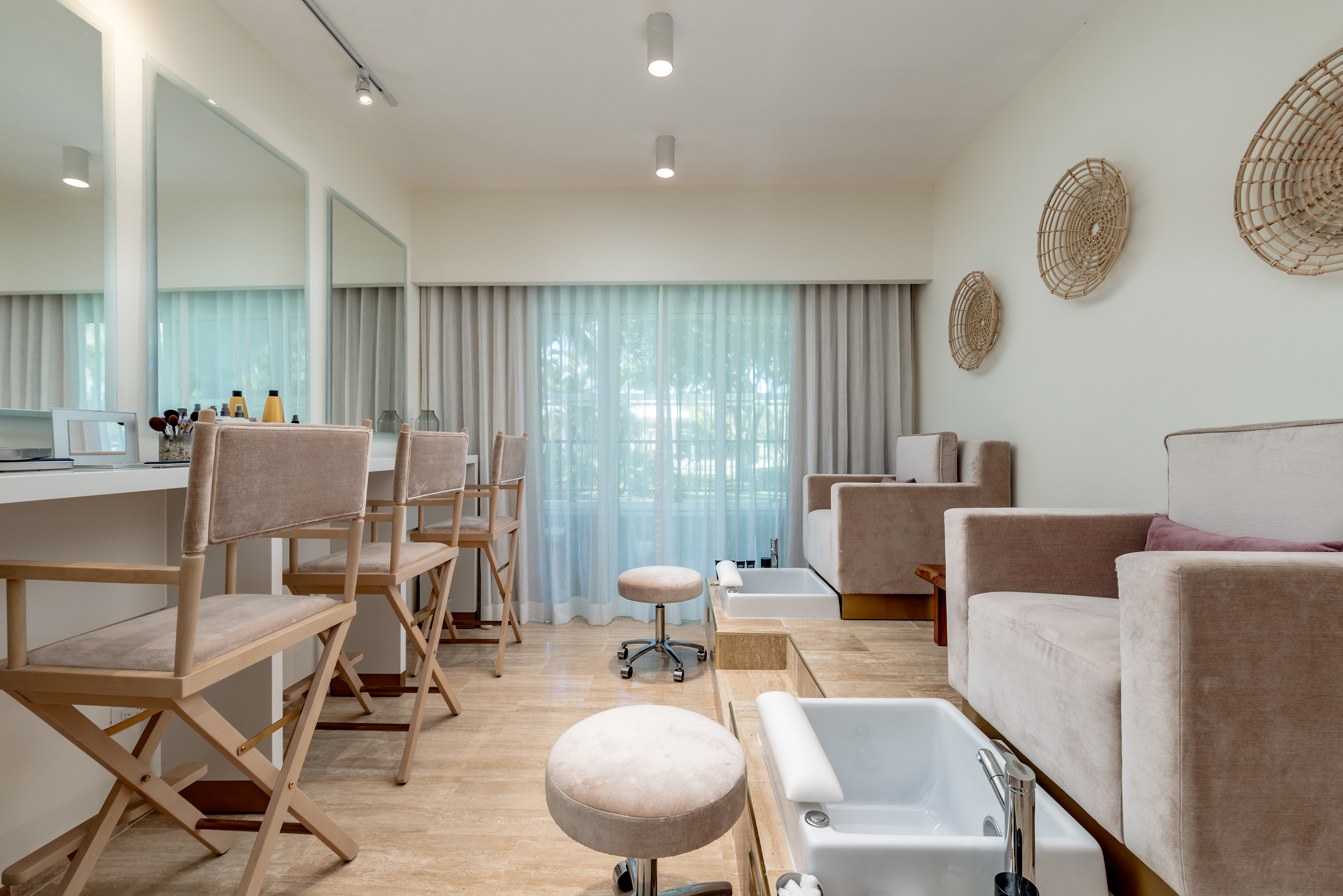 Modern spa salon with plush pedicure chairs, foot baths, and beauty vanity.