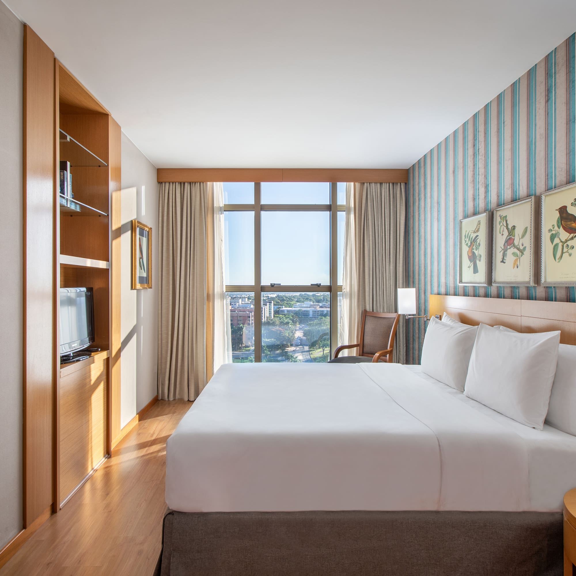 a room with a bed and a television