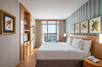 a room with a bed and a television