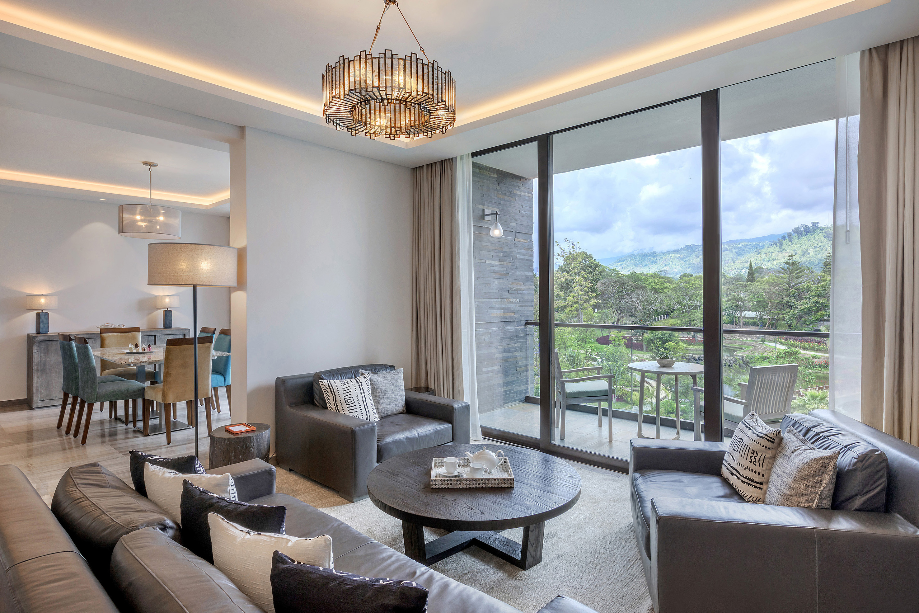 a living room with a large glass wall and a large window