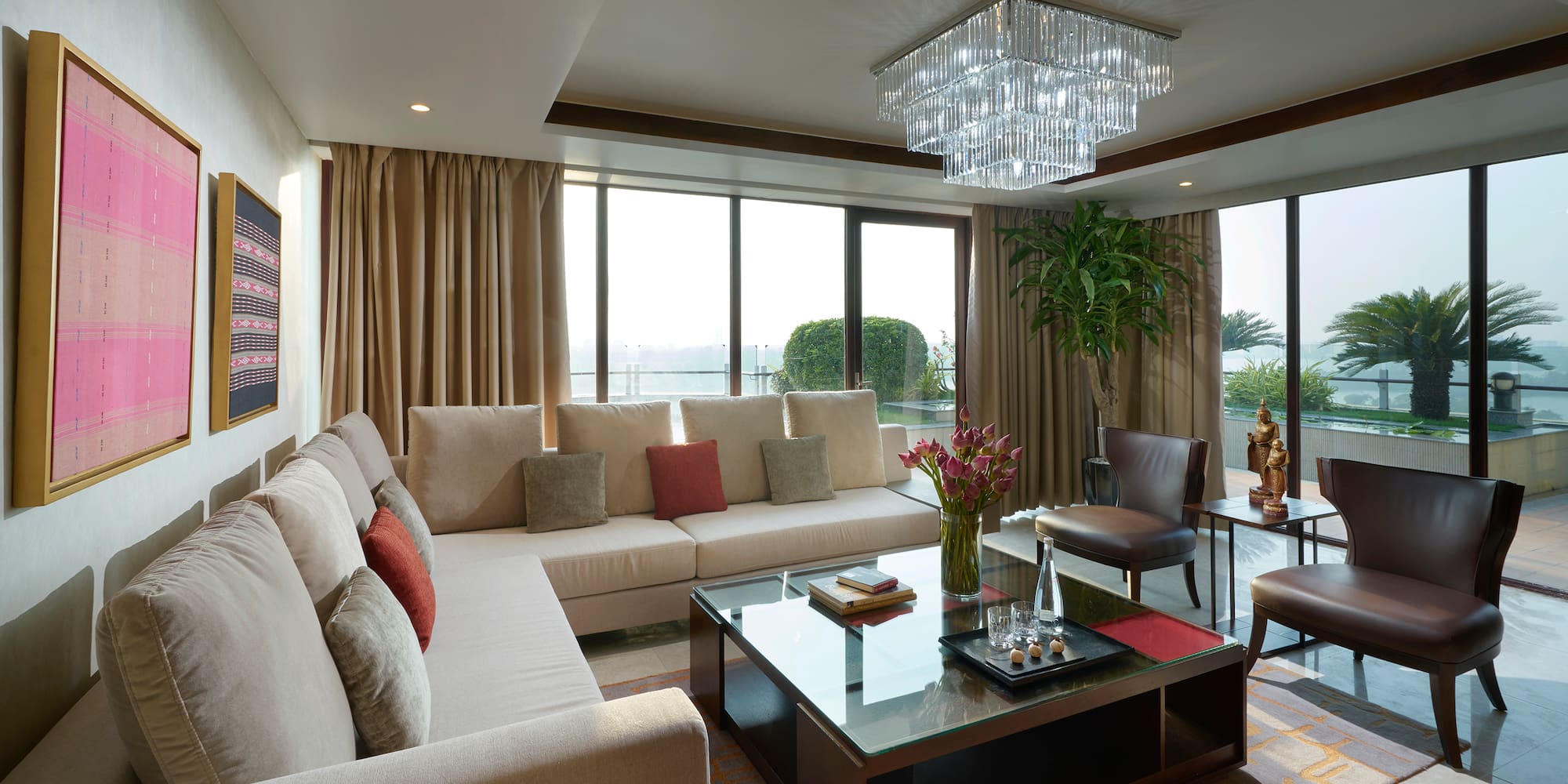 a living room with couches and a glass coffee table