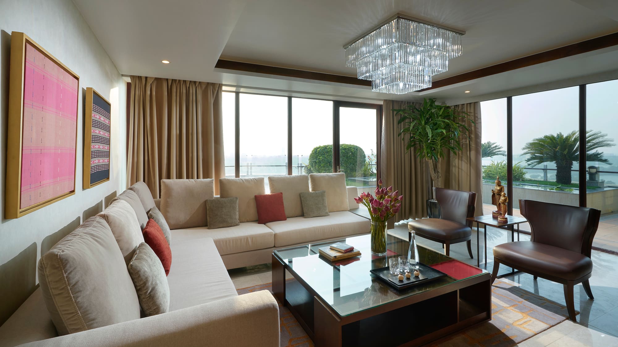 a living room with couches and a glass coffee table