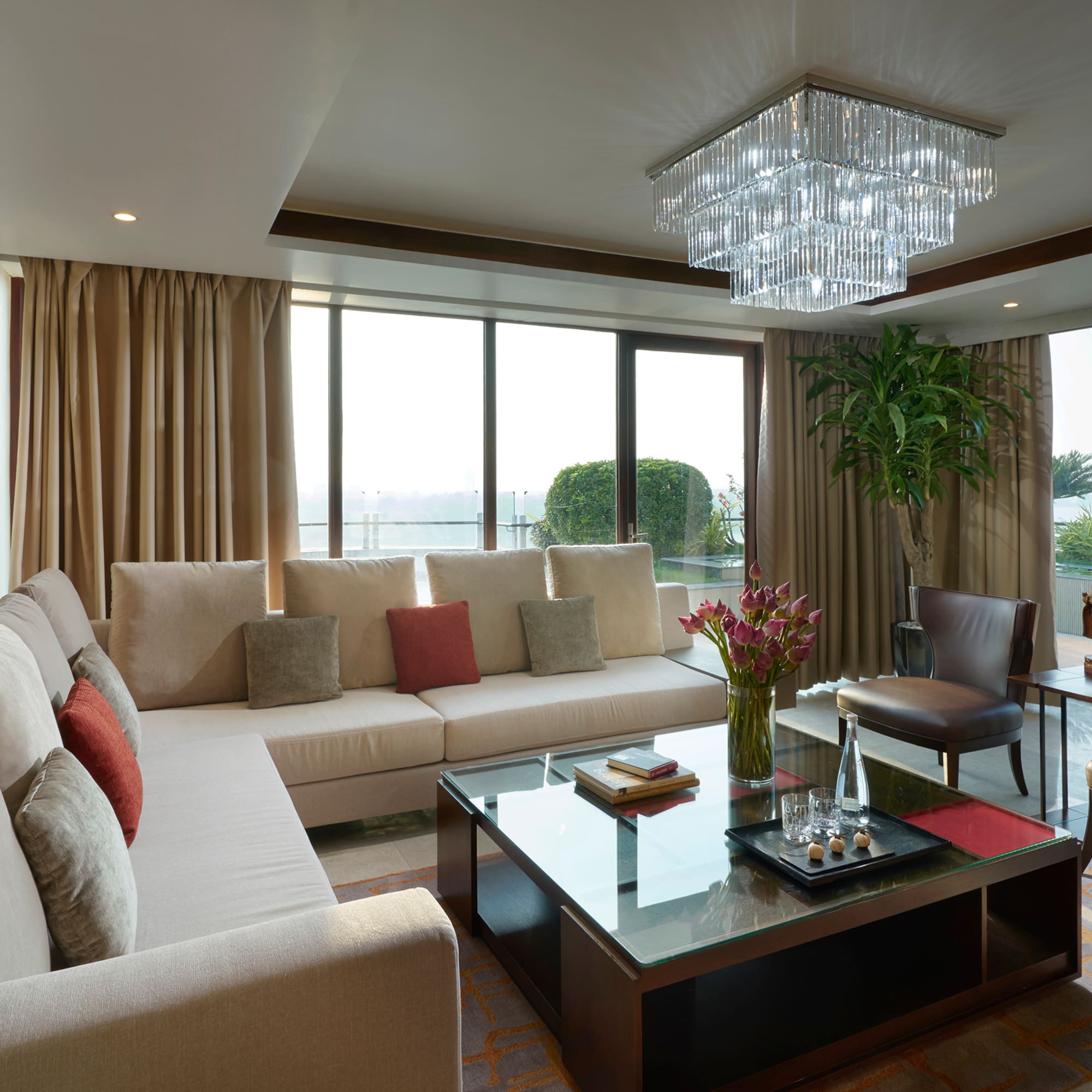 a living room with couches and a glass coffee table