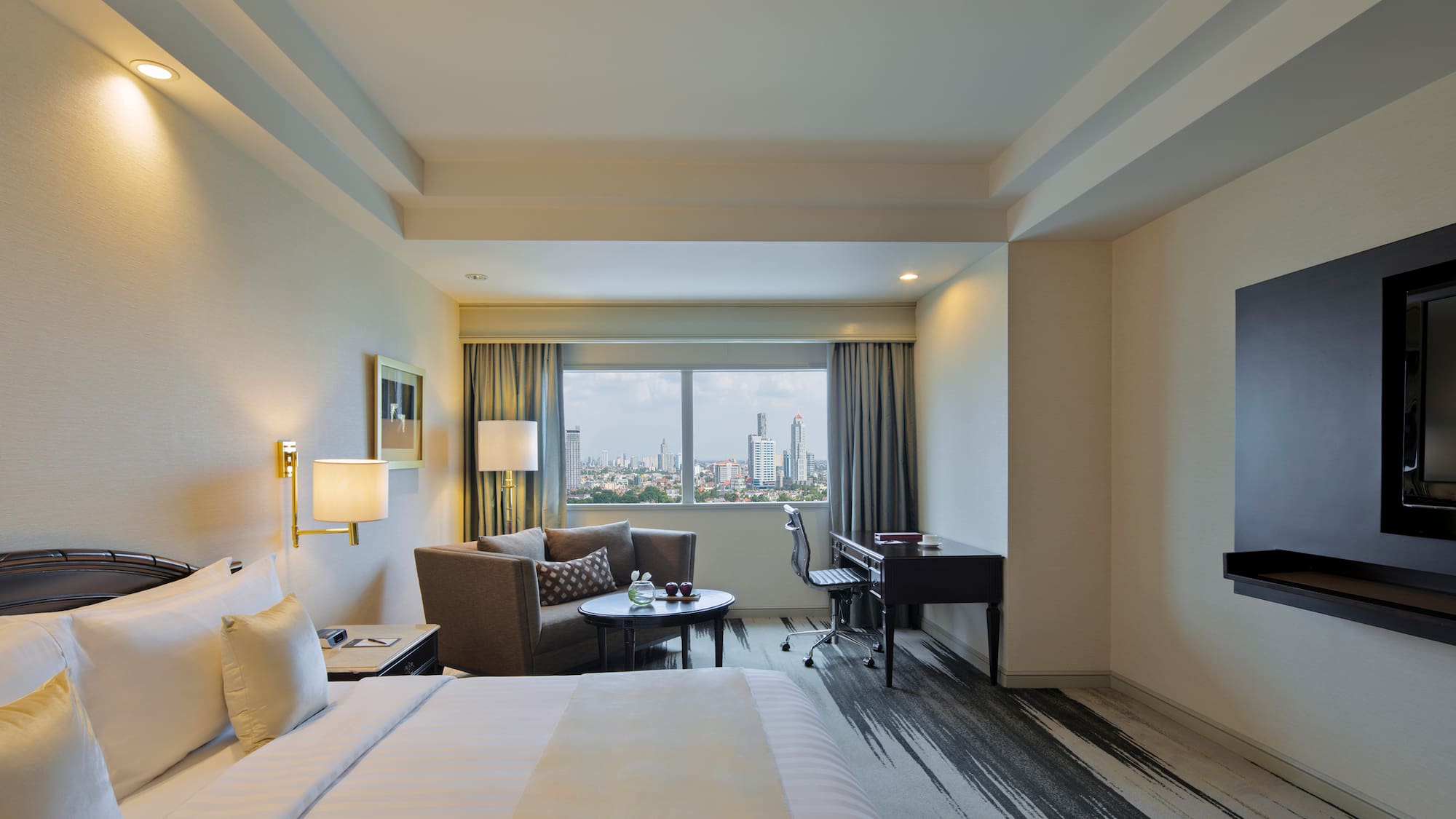 a room with a bed and a desk and a chair
