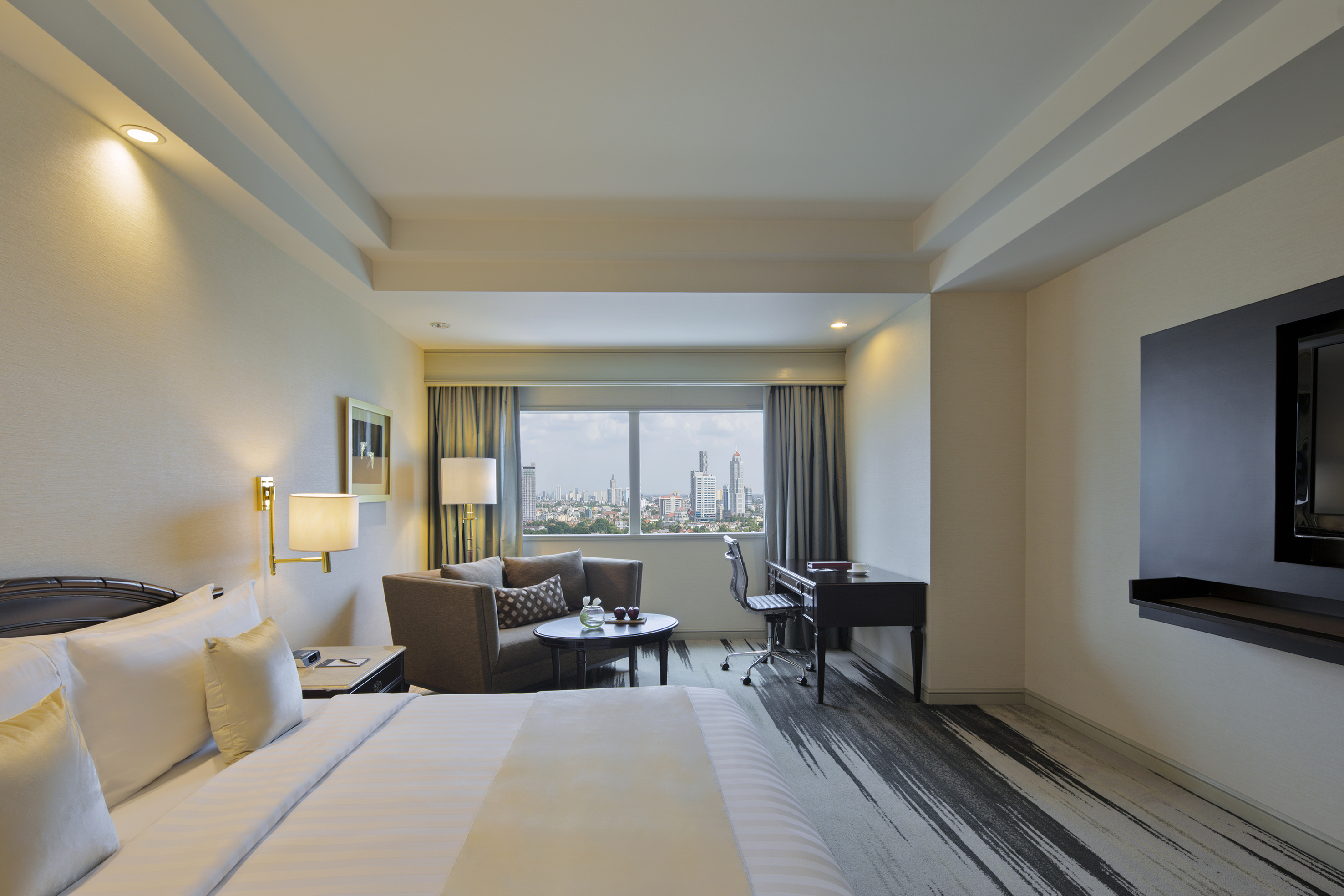 a room with a bed and a desk and a chair