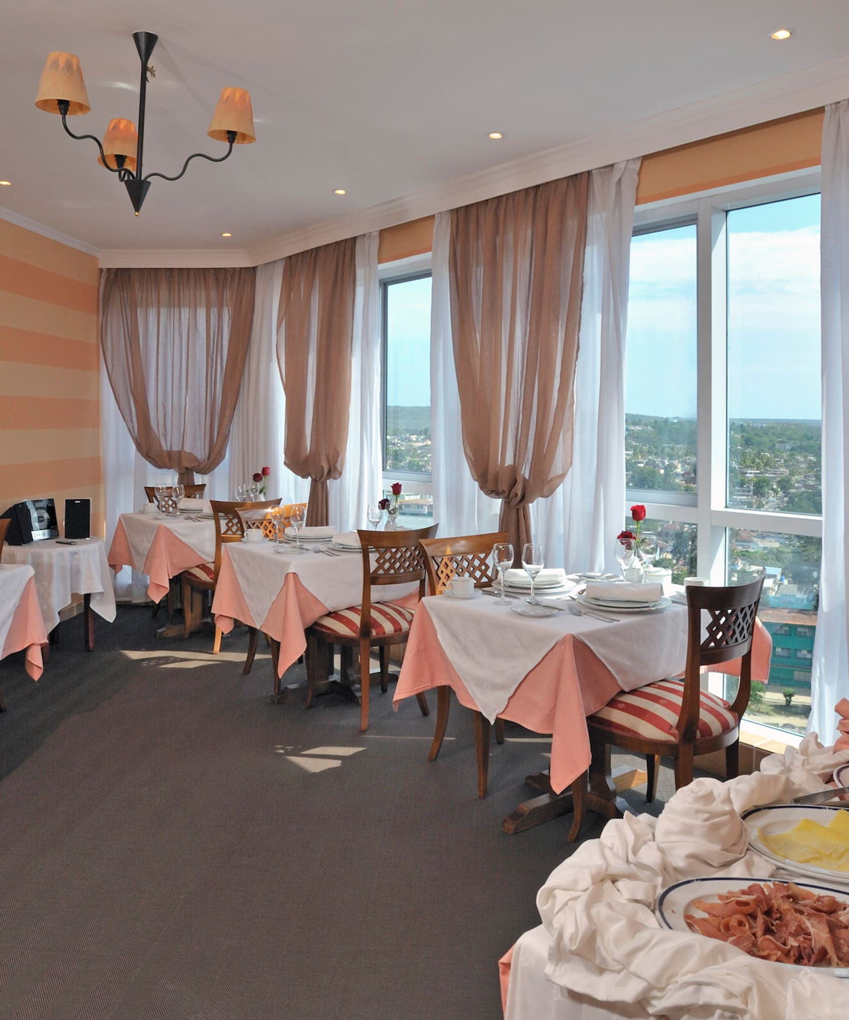 a room with tables and chairs and a window