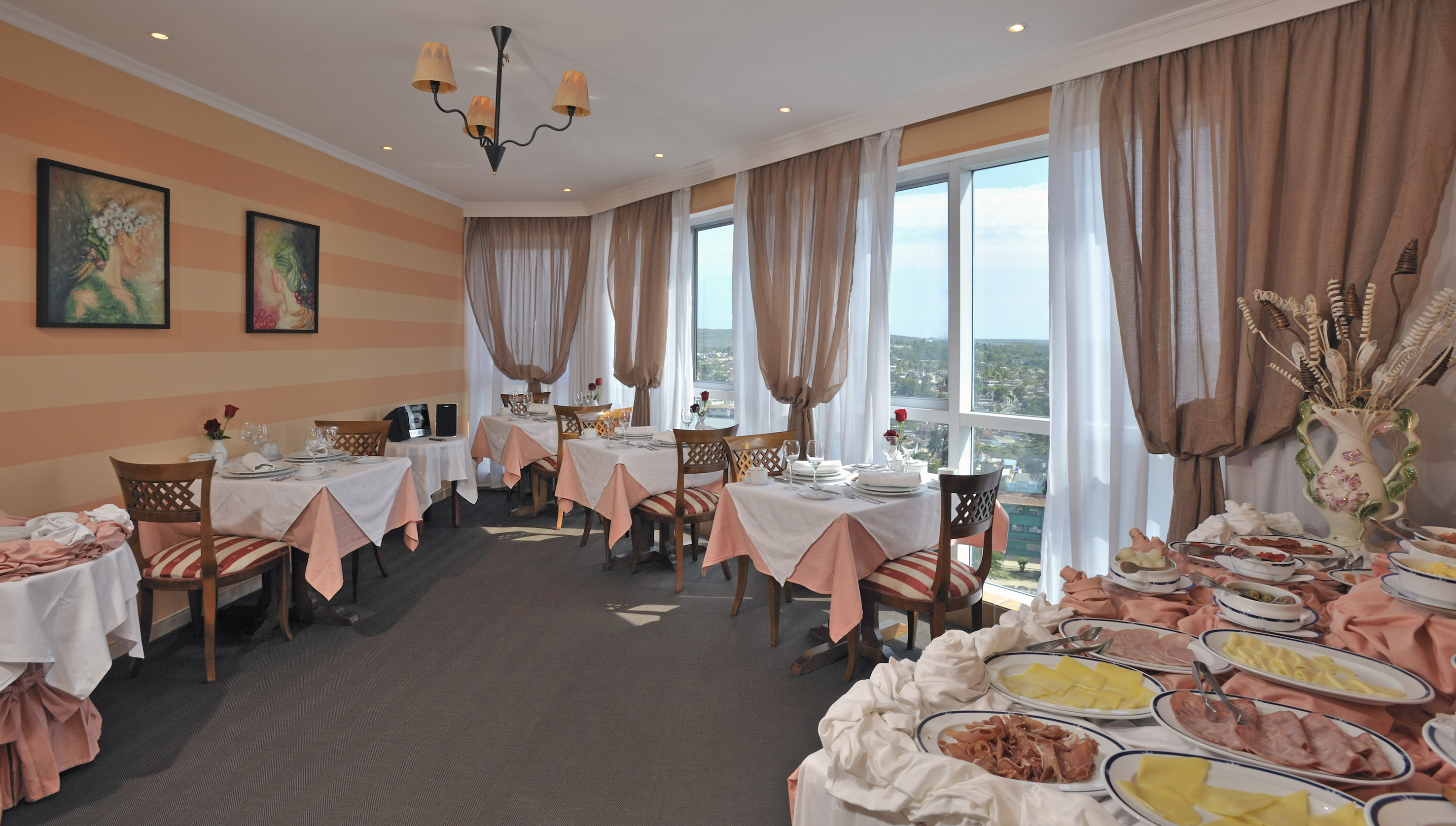 a room with tables and chairs and a window