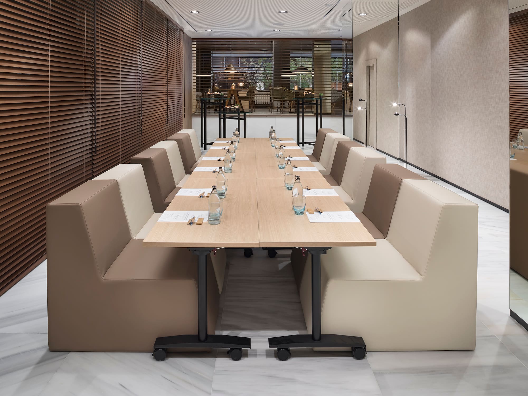 a long table with white chairs and a brown table