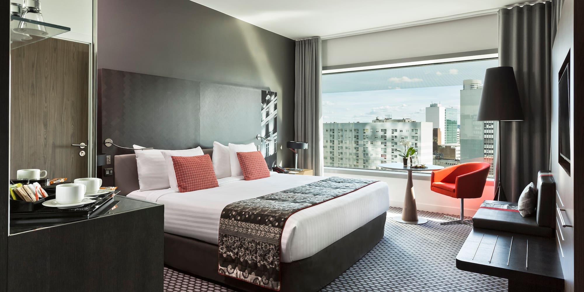 a bedroom with a large bed and a desk