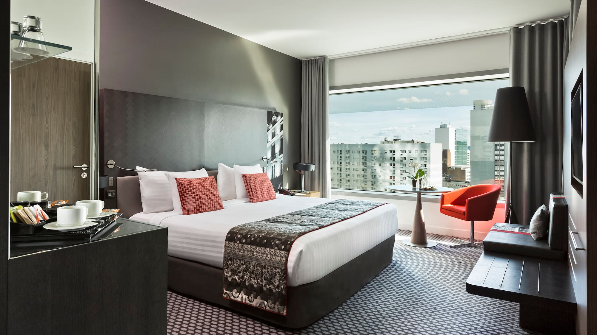 a bedroom with a large bed and a desk