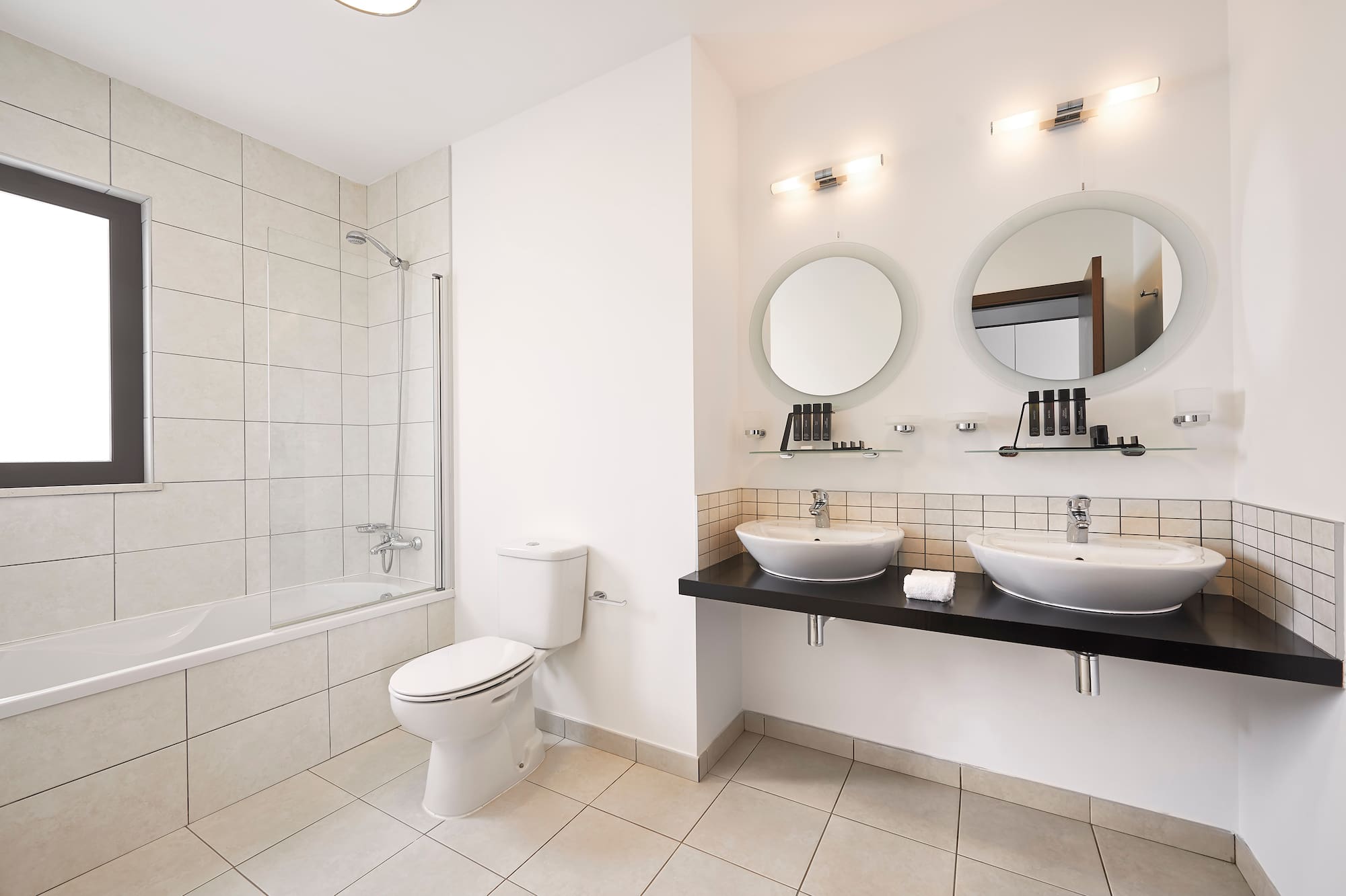 a bathroom with white walls and white tile floor