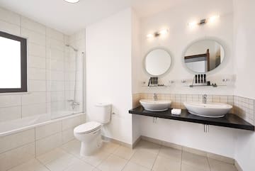 a bathroom with white walls and white tile floor