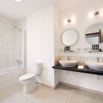 a bathroom with white walls and white tile floor