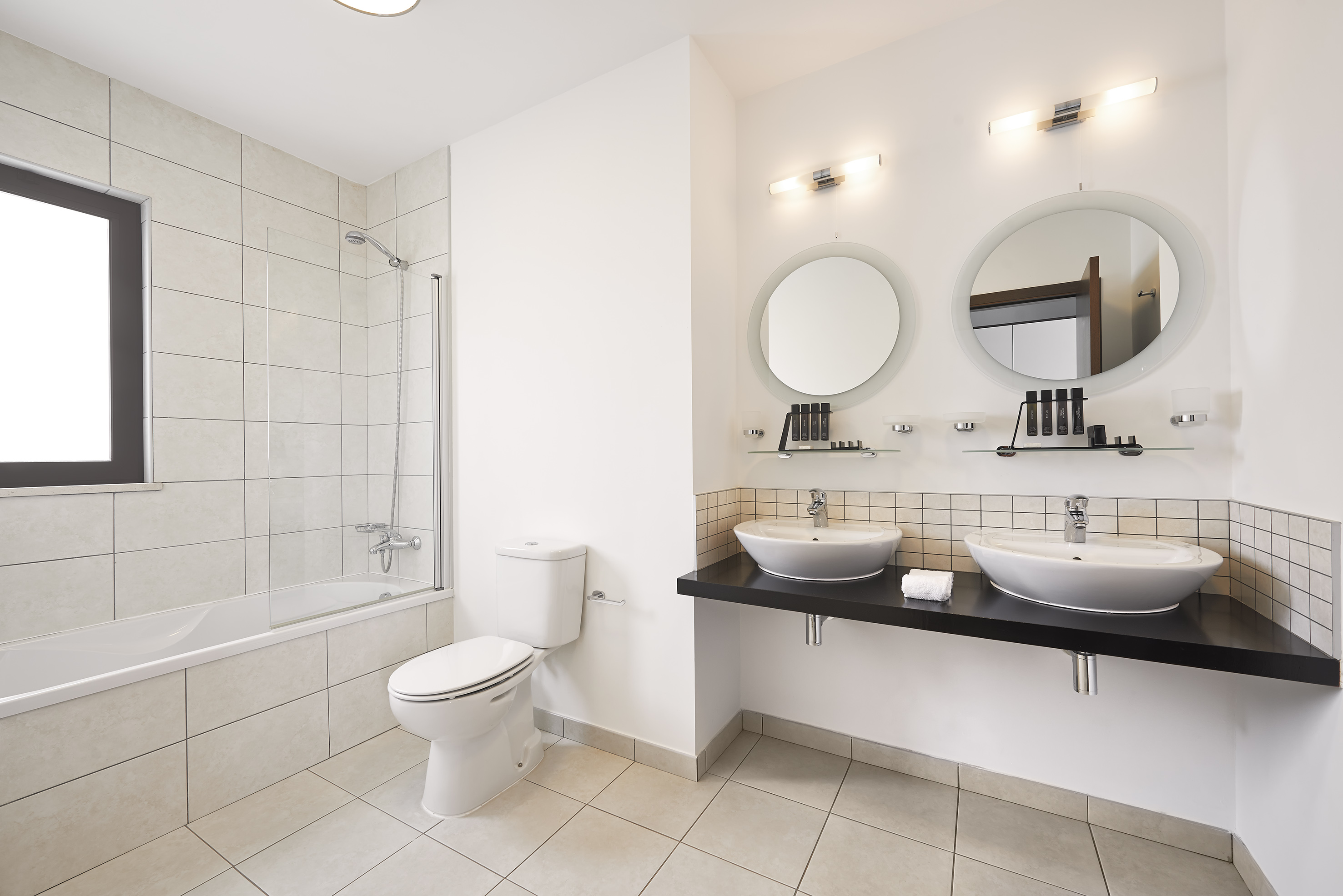 a bathroom with white walls and white tile floor