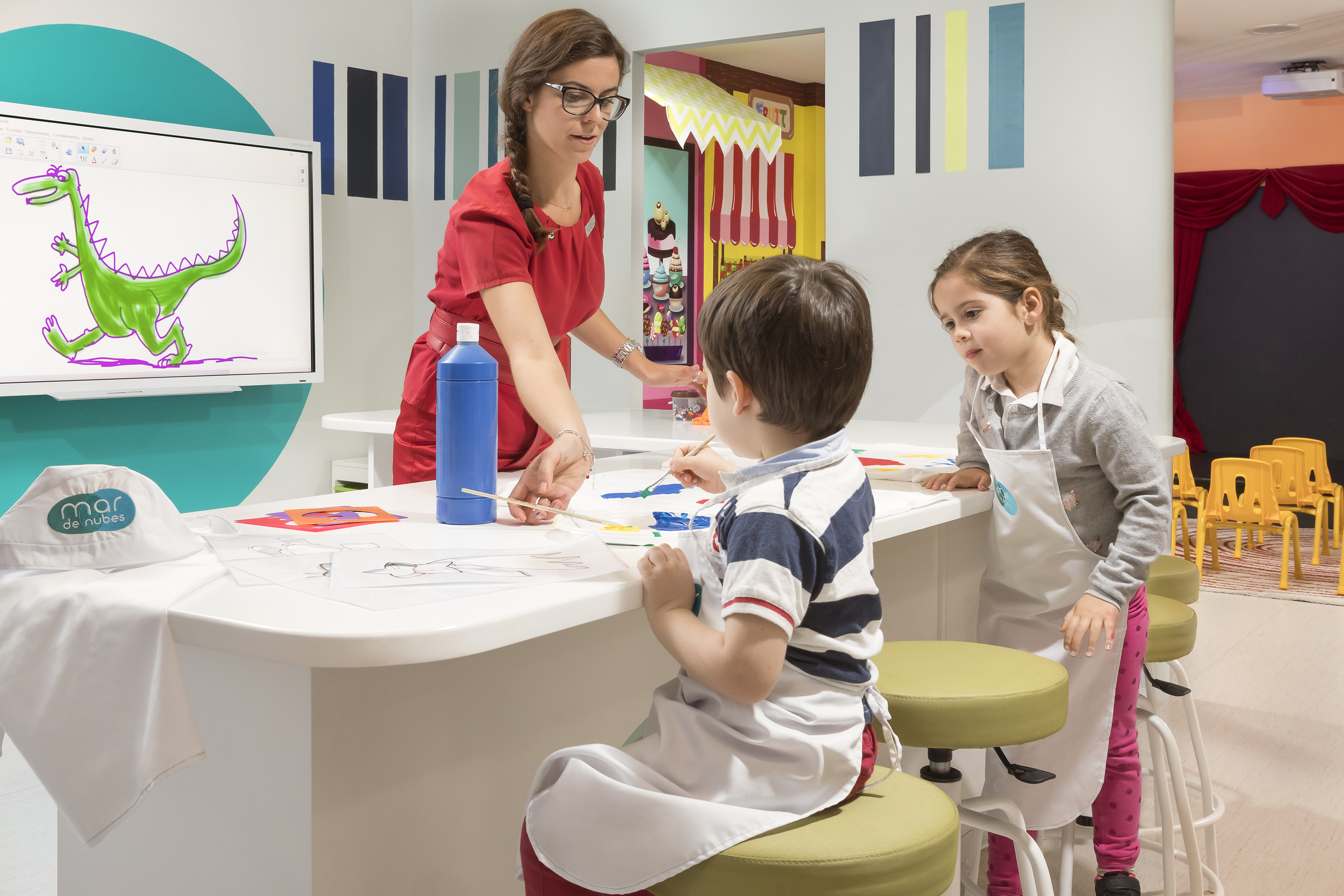 a woman and children painting