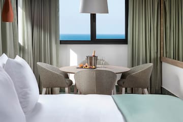 a table with food and chairs in a hotel room