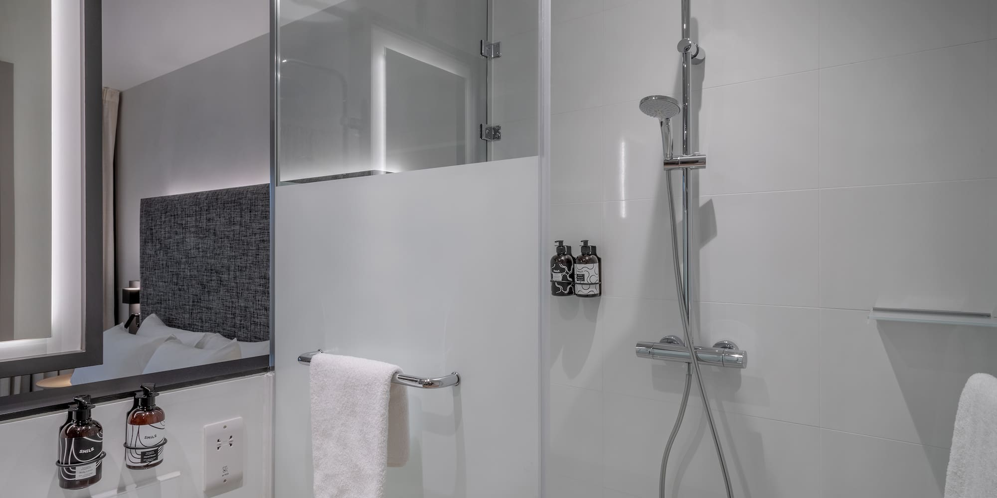 a shower with a towel from the wall