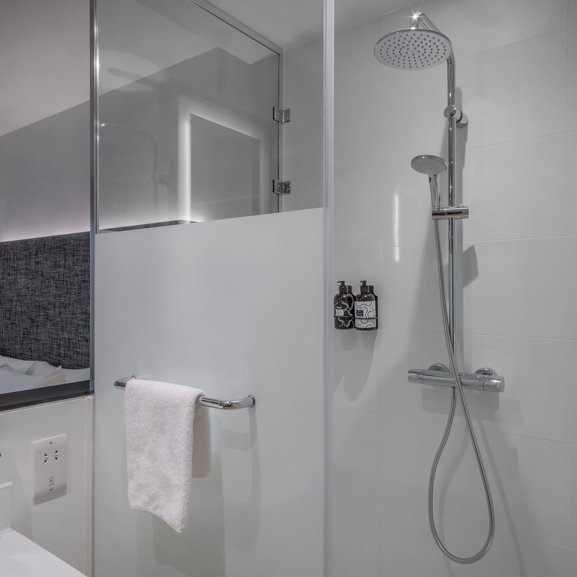 a shower with a towel from the wall