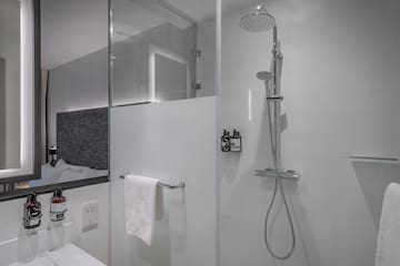 a shower with a towel from the wall