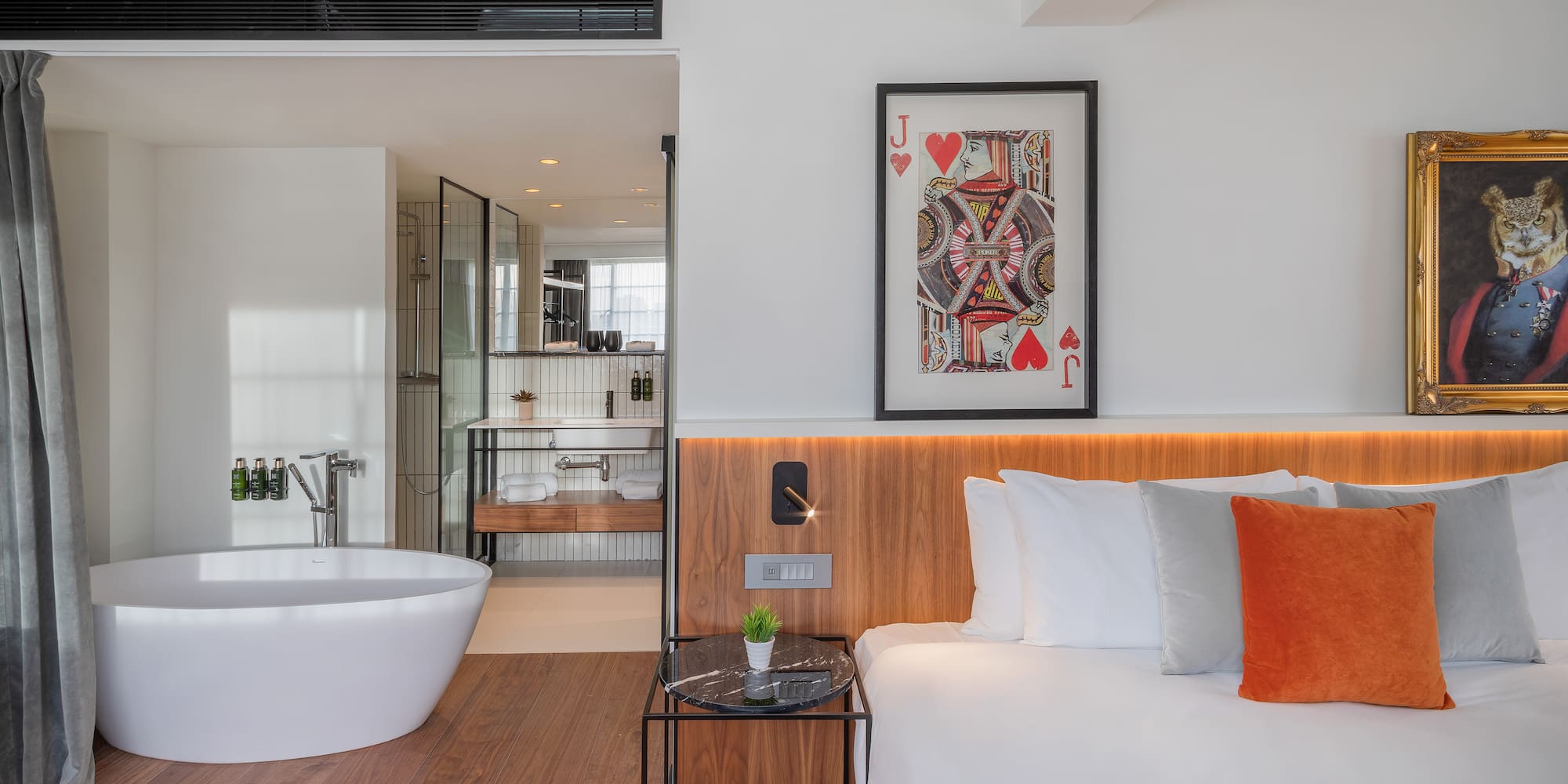 a bedroom with a bathtub and a bed