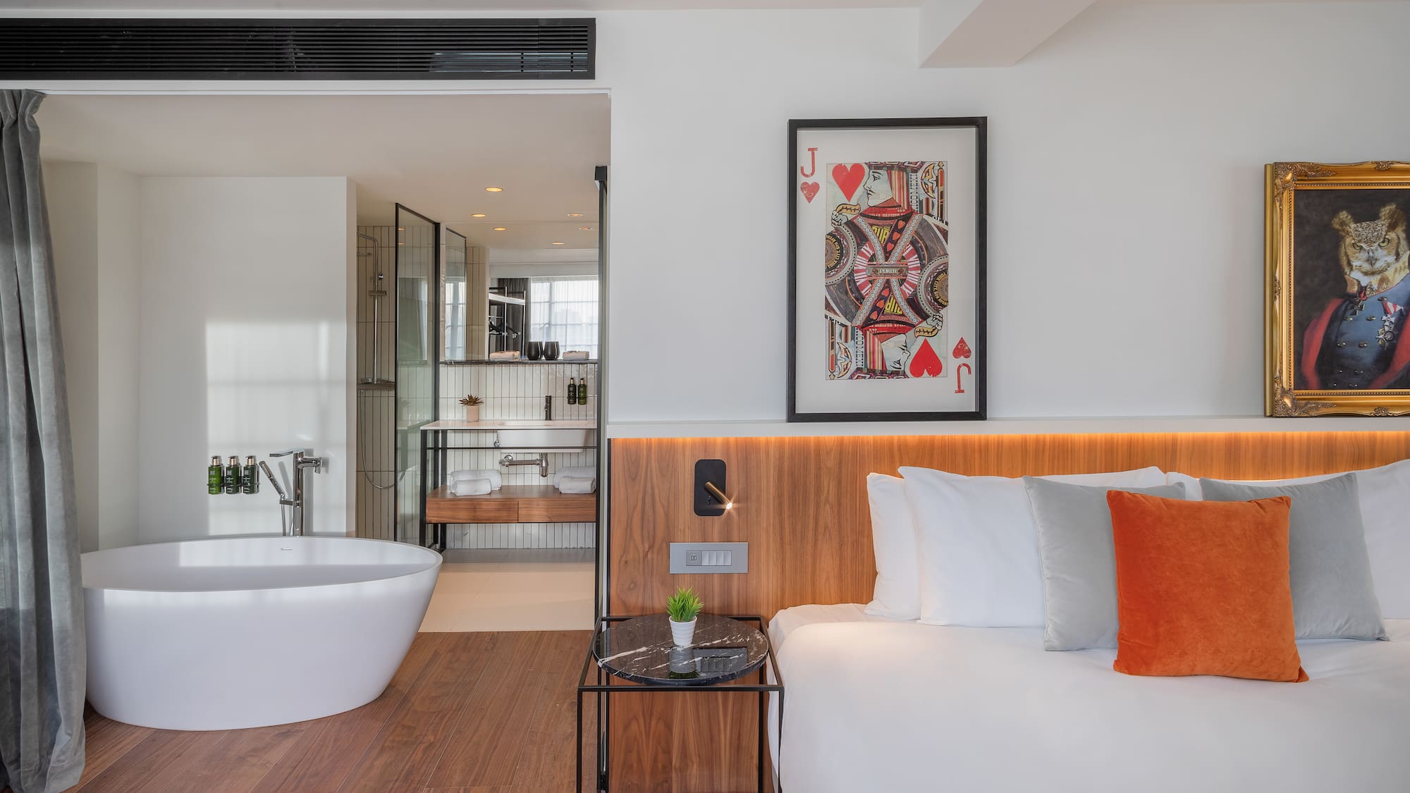 a bedroom with a bathtub and a bed