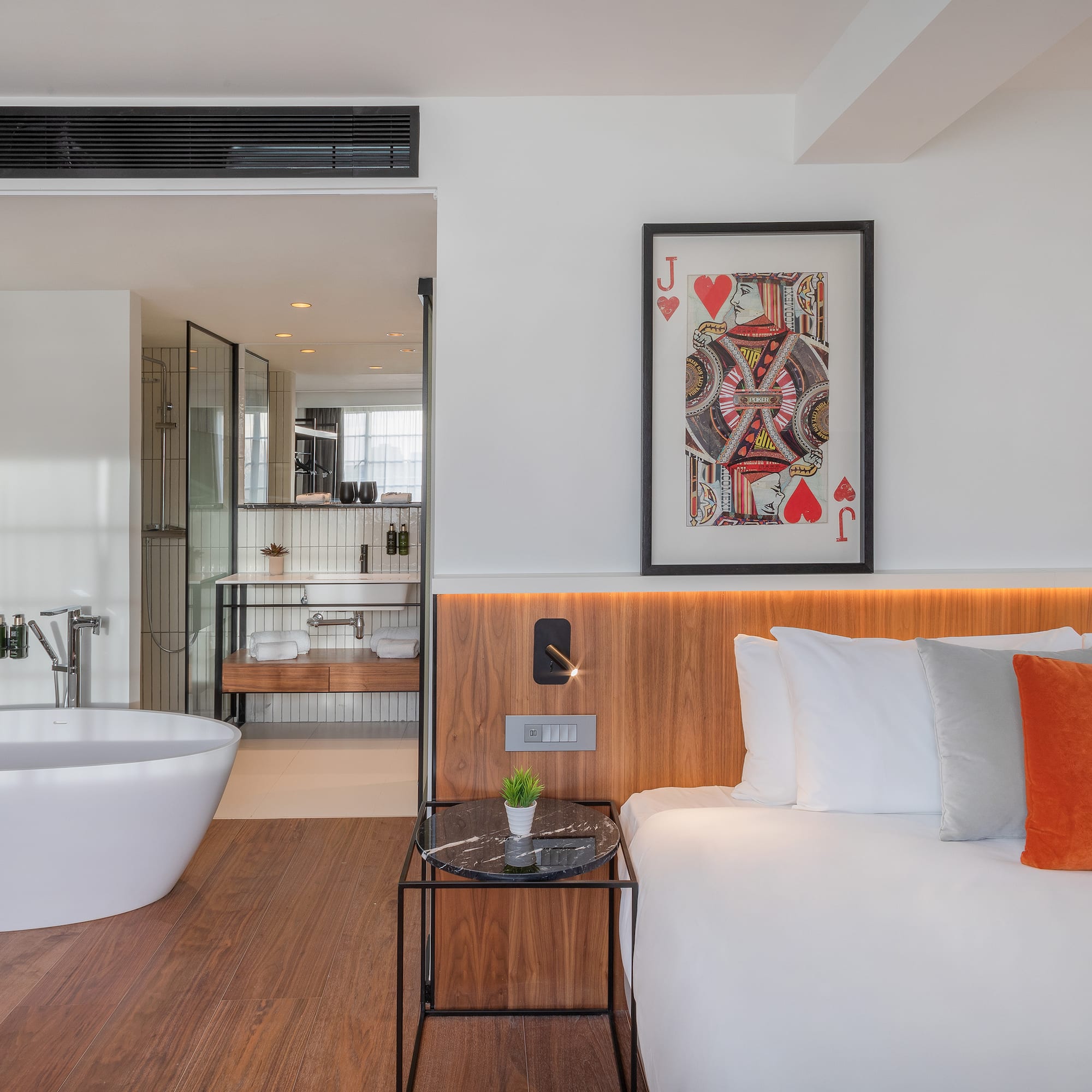 a bedroom with a bathtub and a bed