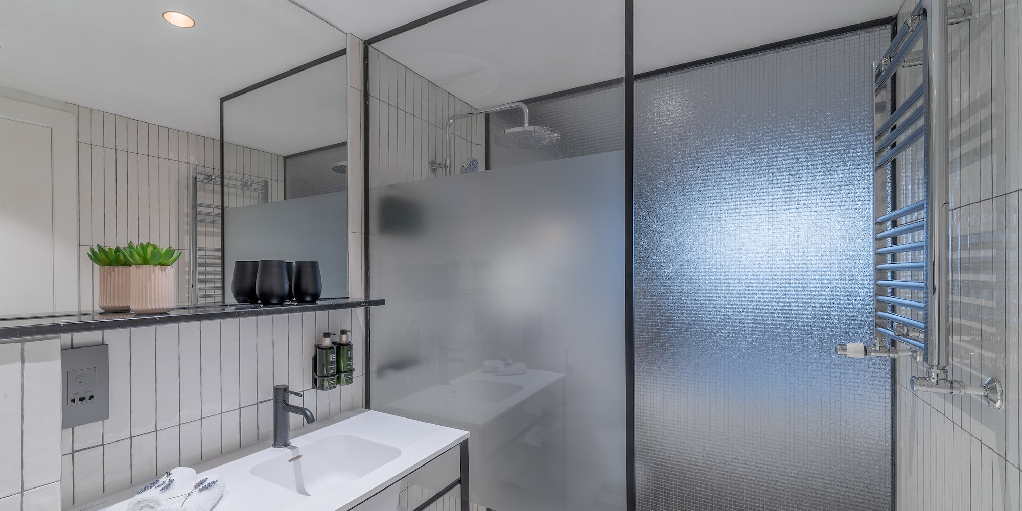 a bathroom with a shower and sink