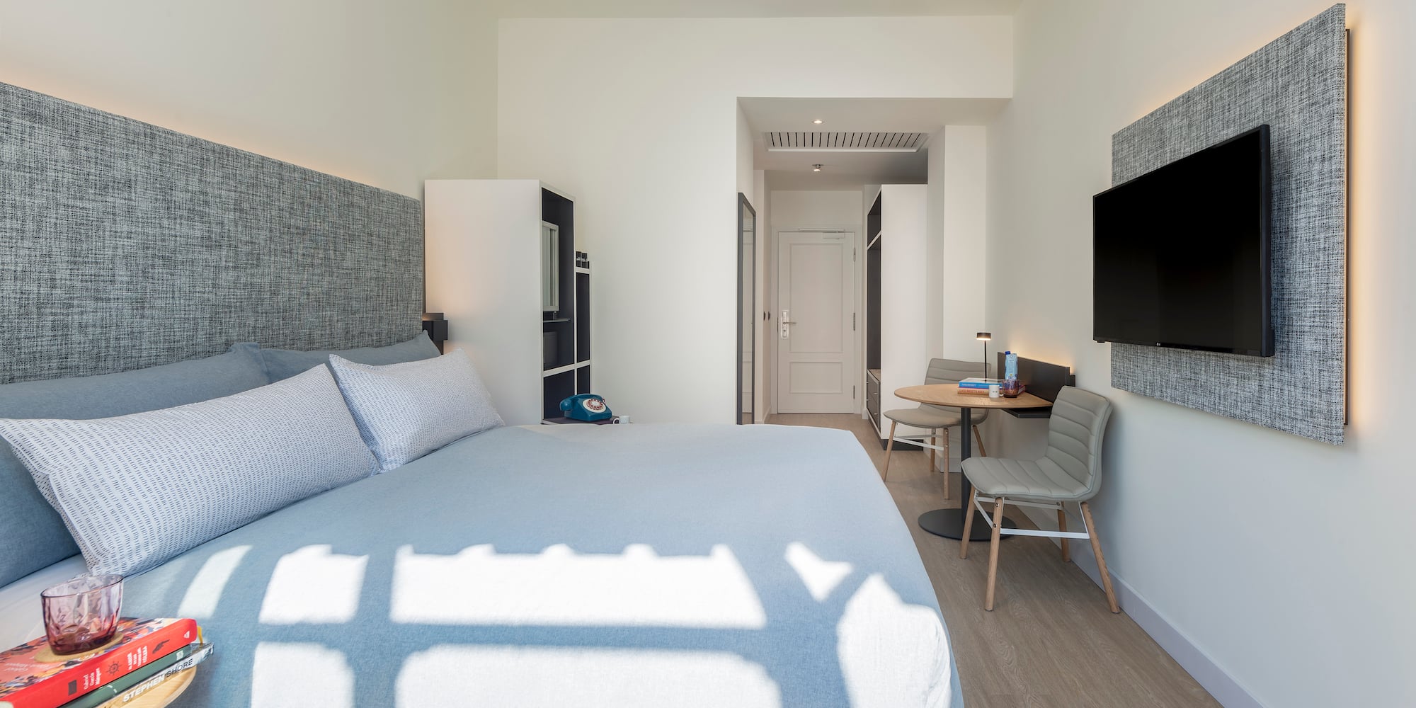 a bedroom with a bed and a tv