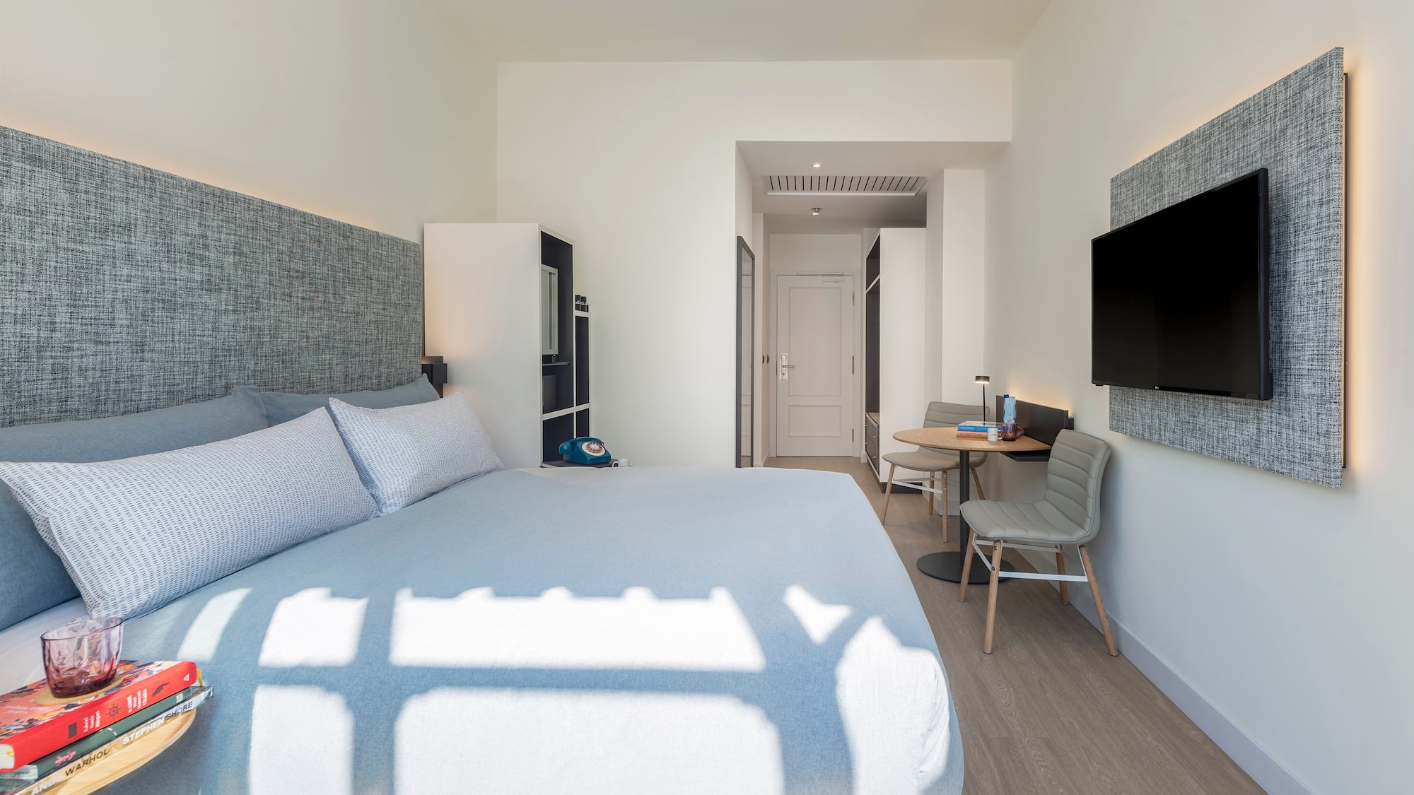 a bedroom with a bed and a tv