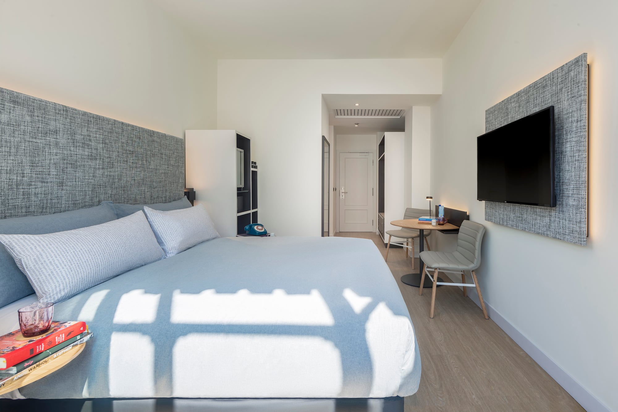 a bedroom with a bed and a tv