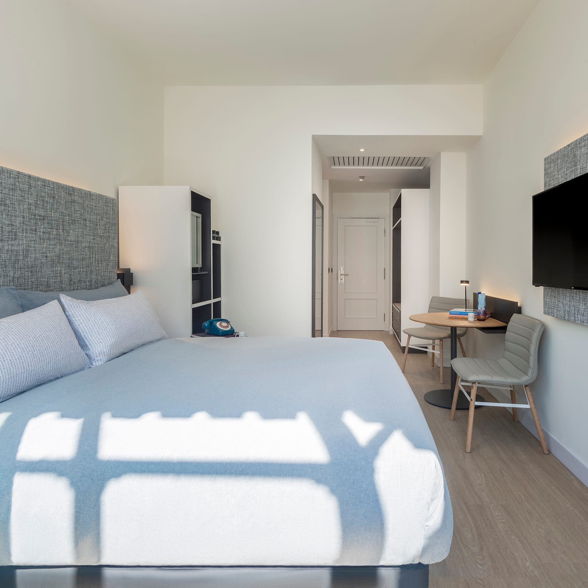 a bedroom with a bed and a tv