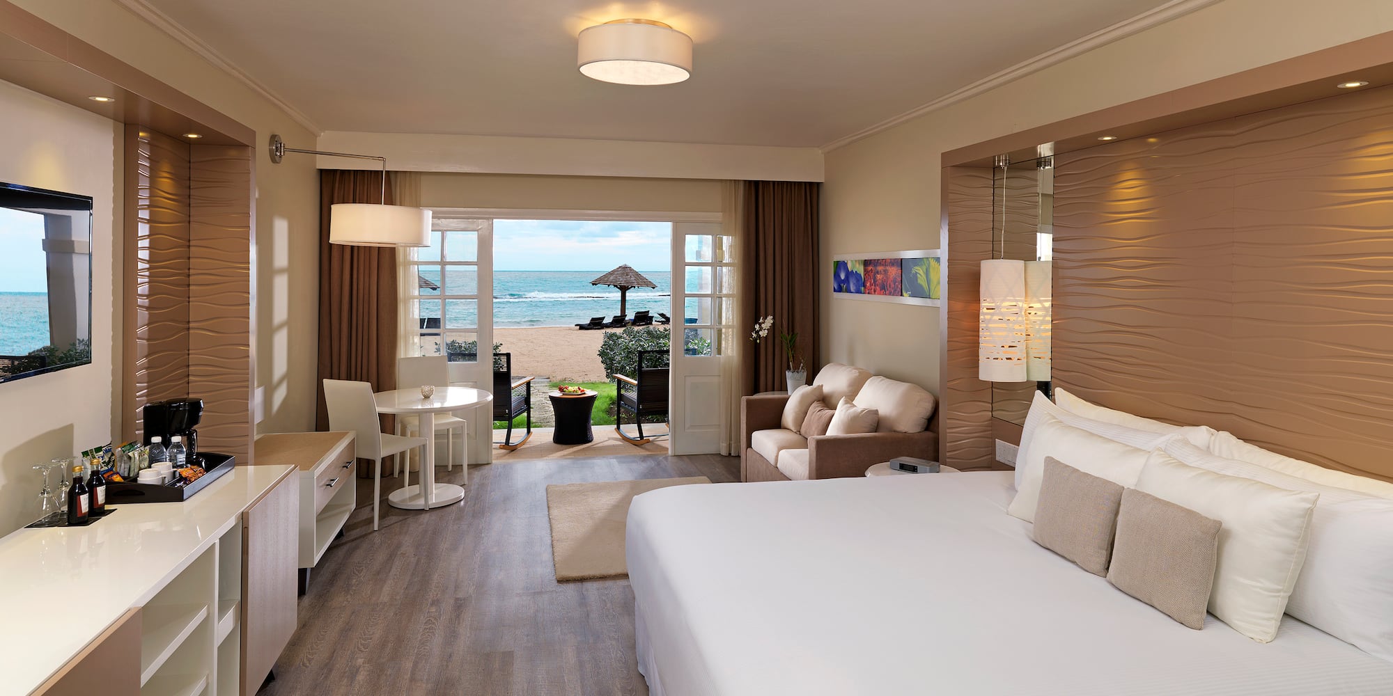 a room with a bed and a table and chairs