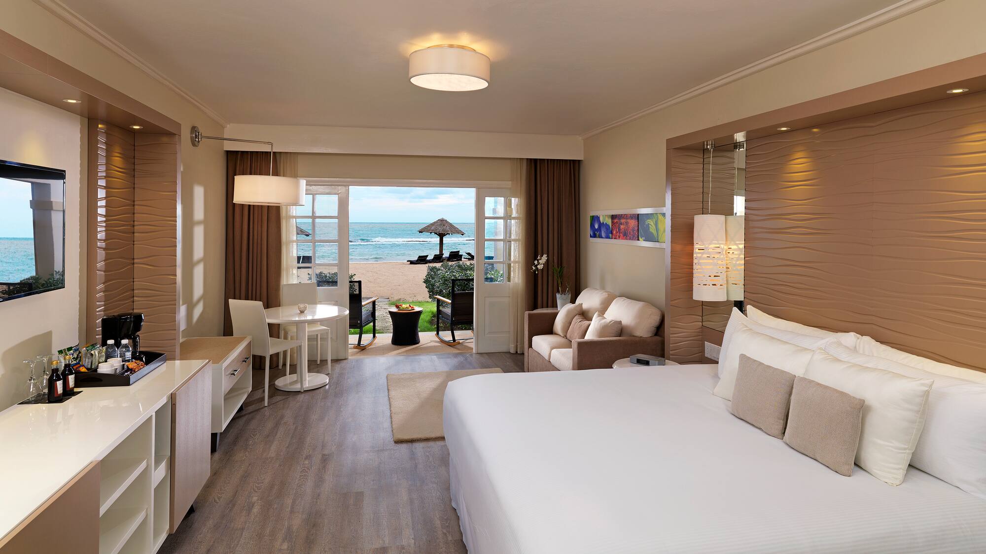 a room with a bed and a table and chairs