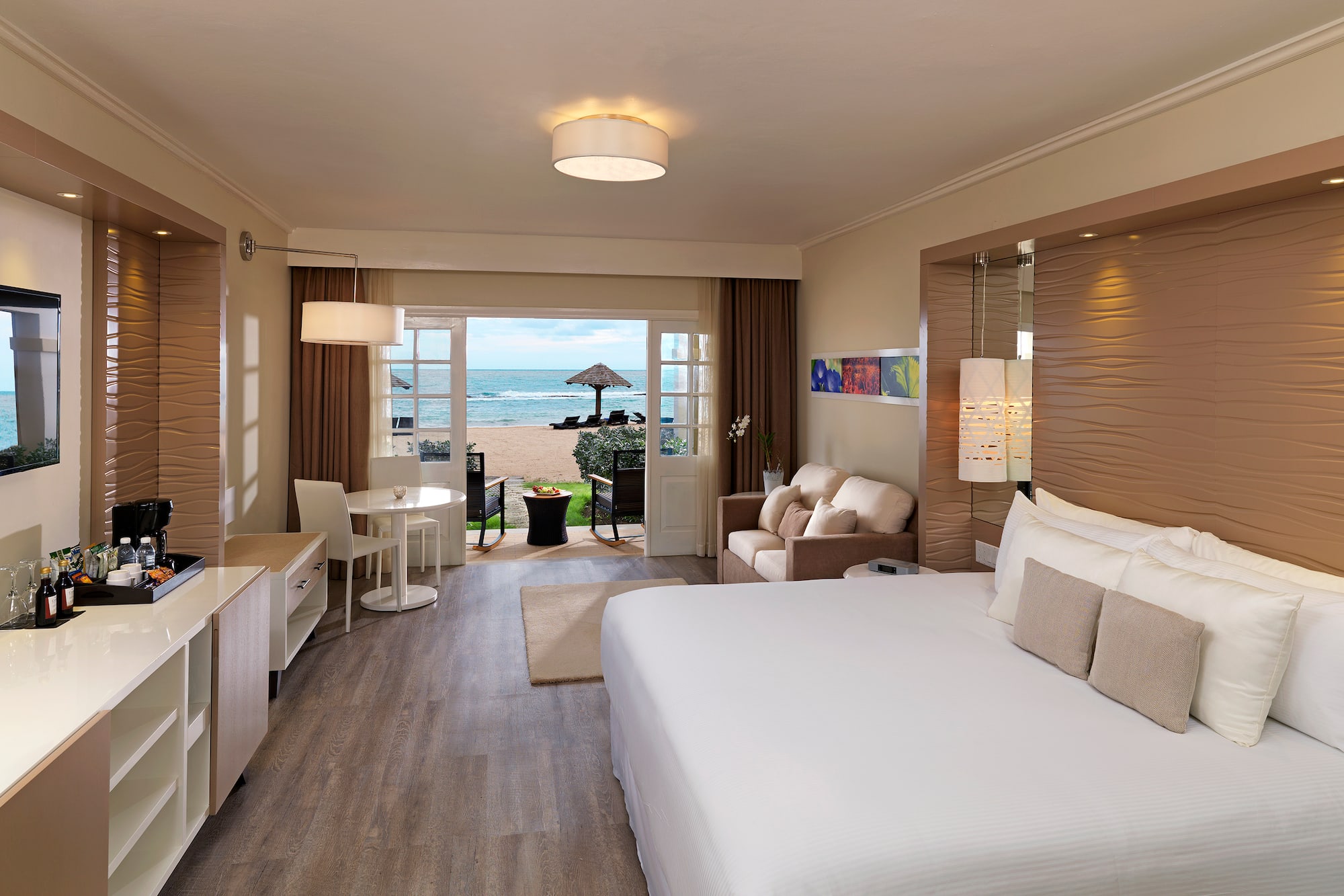 a room with a bed and a table and chairs