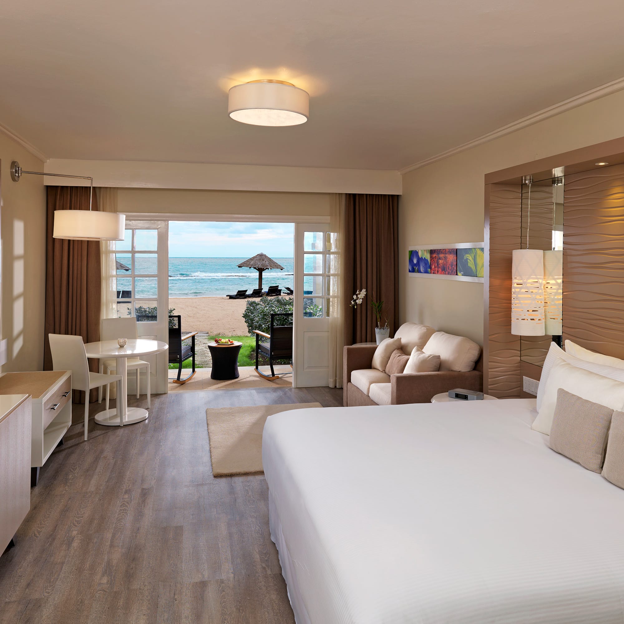 a room with a bed and a table and chairs