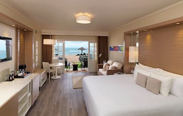 a room with a bed and a table and chairs