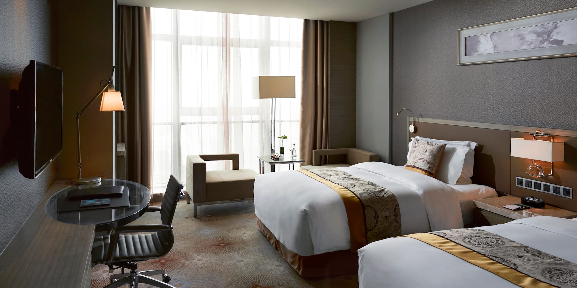 a hotel room with two beds and a desk