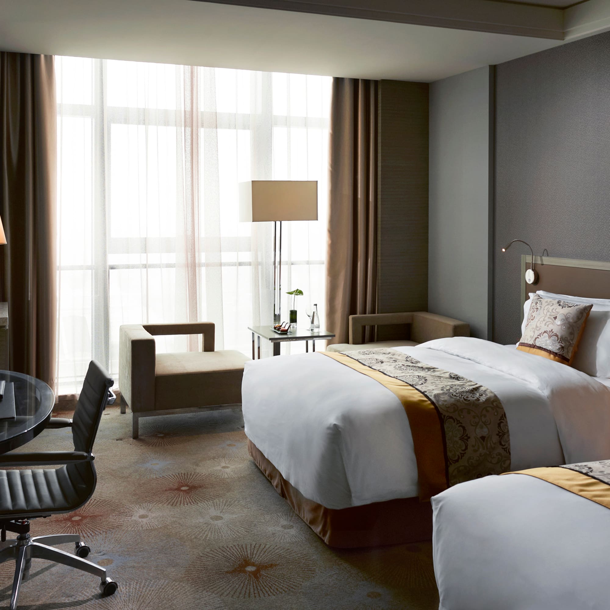 a hotel room with two beds and a desk